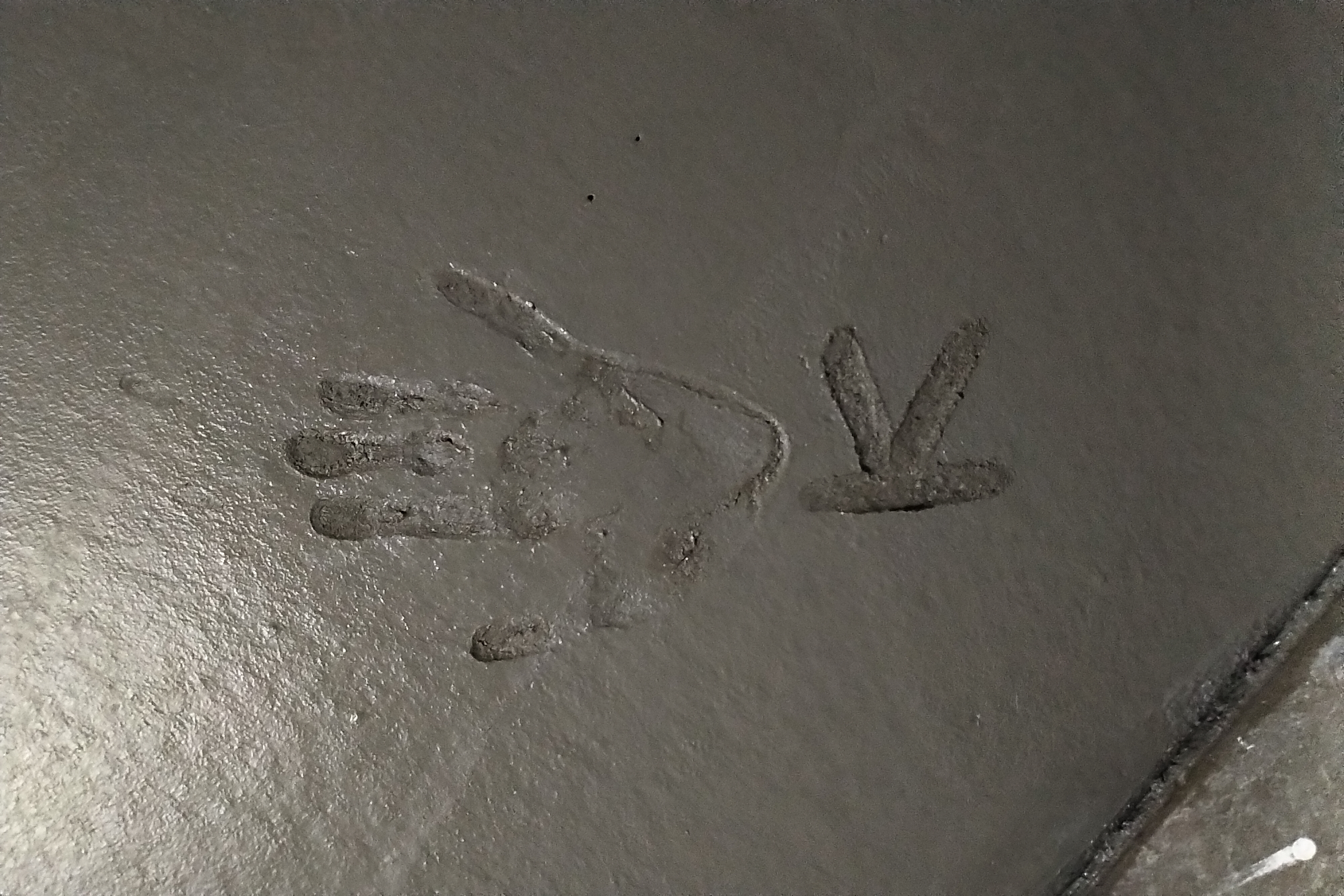 K hand print in concrete